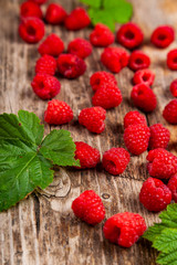 Ripe raspberry on an old wooden table.