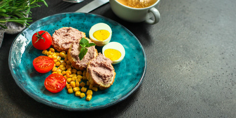 Breakfast snack, tasty food (pate, toast, tomato, corn, egg, coffee). top view. food background
