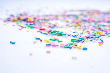 Colorful candy sprinkles close up for birthday cake on white background