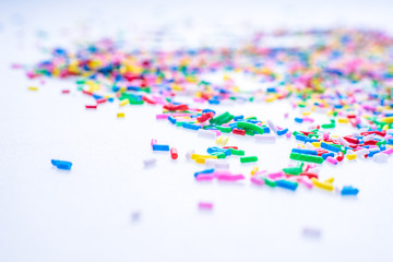 Fototapeta na wymiar Colorful candy sprinkles close up for birthday cake on white background
