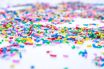 Colorful candy sprinkles close up for birthday cake on white background