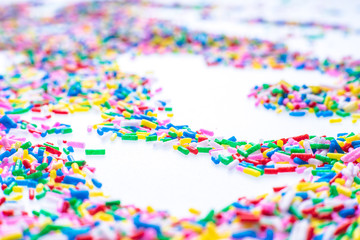 Colorful candy sprinkles close up for birthday cake on white background