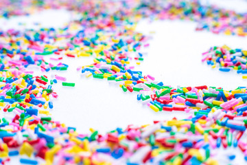 Colorful candy sprinkles close up for birthday cake on white background