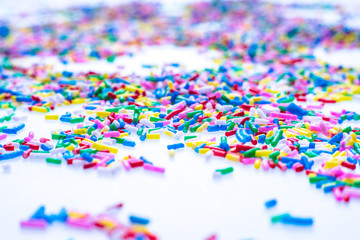 Colorful candy sprinkles close up for birthday cake on white background