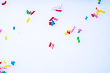 Colorful candy sprinkles close up for birthday cake on white background
