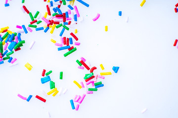 Colorful candy sprinkles close up for birthday cake on white background