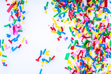 Colorful candy sprinkles close up for birthday cake on white background