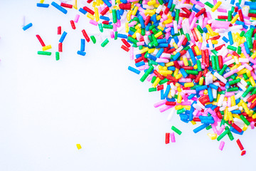 Colorful candy sprinkles close up for birthday cake on white background