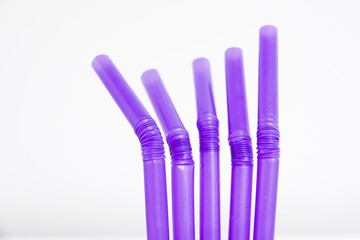 Purple straws isolated over a white background