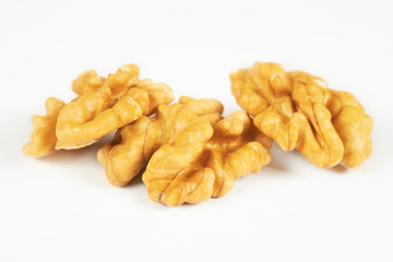 Walnuts isolated on white background. Pile of walnuts without shell closeup for your design and print. Nuts collection