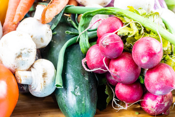 Colourful assorted raw vegetables on a wooden cutting board. Calgary, Alberta, Canada