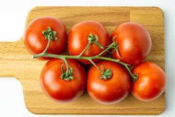 Fresh organic red tomatoes on white background. Selective focus.