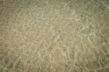 droped sungrass and small waves lapped the beach