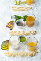 Obraz na płótnie Canvas Fruit, greens, juice and matcha ingredients isolated on white background to make your perfect detox healthy smoothie