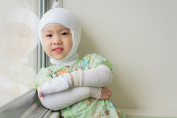 Asian baby girl are sick with Atopic dermatitis, She was wrapped with a bandage on the head neck arms and legs.