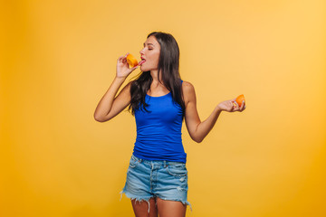 Girl on a yellow background with oranges.