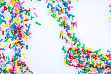 Colorful candy sprinkles close up for birthday cake on white background