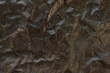 The brown stone wall. Texture similar to crumpled paper. Original abstract background for design.