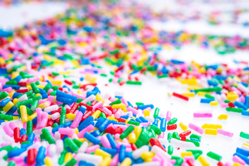 Colorful candy sprinkles close up for birthday cake on white background