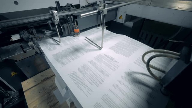 Typographic conveyor works with printed paper with text.