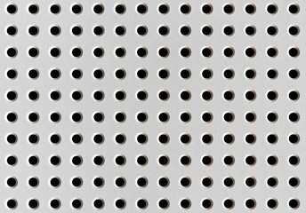 white metal plate with round holes
