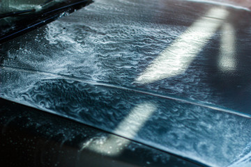 Car wash, foam and water.