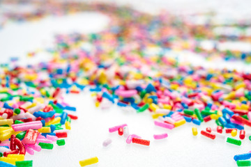 Colorful candy sprinkles close up for birthday cake on white background