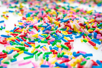 Colorful candy sprinkles close up for birthday cake on white background