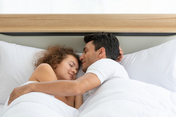 Happy couples relaxing in the white bedroom Of the apartment With various emotions With snacks, coffee, fruit in the morning