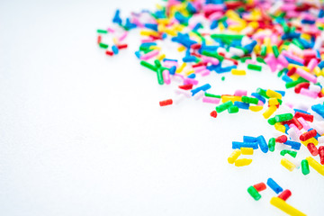 Colorful candy sprinkles close up for birthday cake on white background
