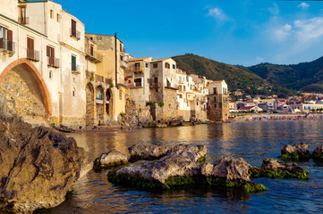 Fototapeta na wymiar Attractive evening cityscape of Cefalu town. Amazing sunset on Mediterranean sea, Sicily, Italy, Europe. Traveling concept background.