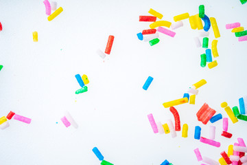 Colorful candy sprinkles close up for birthday cake on white background