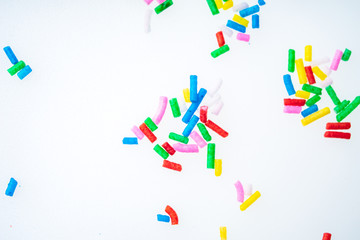 Colorful candy sprinkles close up for birthday cake on white background