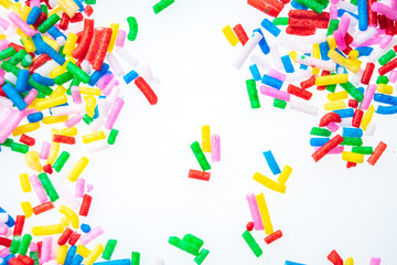 Colorful candy sprinkles close up for birthday cake on white background