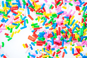 Colorful candy sprinkles close up for birthday cake on white background