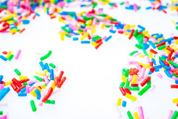 Colorful candy sprinkles close up for birthday cake on white background