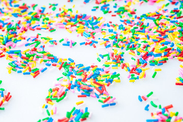 Colorful candy sprinkles close up for birthday cake on white background