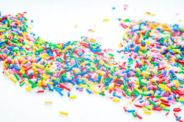 Colorful candy sprinkles close up for birthday cake on white background