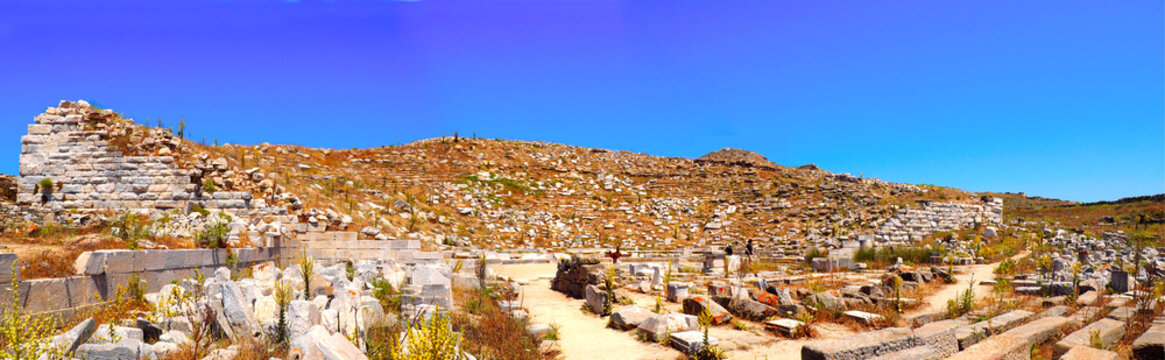 panoramic view of the ancient theater in the archaeological city of Delos Island, near Mykonos, beautiful Cycladic island, in the heart of the Aegean Sea