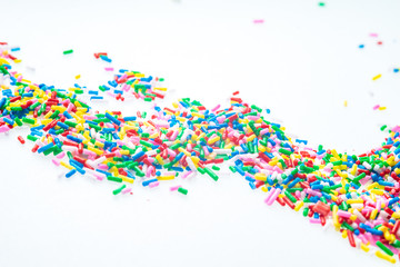 Colorful candy sprinkles close up for birthday cake on white background