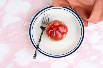 top view strawberry glazed tart with a napkin