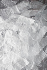 Plastic bag with handles, gloves, on a black background . Used plastic bag for recycling. Concept - ecology, planet pollution with plastic cellophane polyethylene