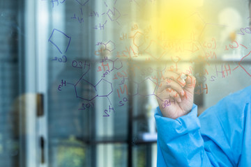 Chemistry teacher writing molecule diagram, Scientist drawing chemical formulas on clear glass...