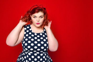 Pin up girl vintage. Beautiful woman pinup style portrait in retro dress and makeup, manicure nails hands, red lipstick and polka dot dress. Studio shot.