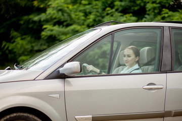 Fototapeta na wymiar Pretty, young woman driving a car -Invitation to travel. Car rental or vacation