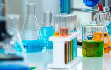 Close up Test Tube containing chemical liquid and lab glassware in laboratory. Laboratory research and development concept.