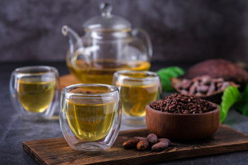 Hot Cacao Tea. Fresh hot chocolate herbal tea made of cacao bean flakes, which is rich in flavonoids and antioxidants, served in glasses, Selective Focus