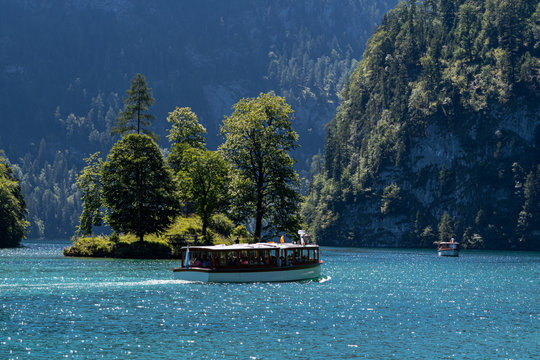 View of Konigssee with the island and passenger boat from Schonau in Bavaria, Germany, Europe in the summer of 2019