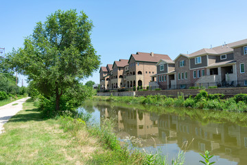 Fototapeta na wymiar Townhouses along a Canal in Suburban Lemont Illinois