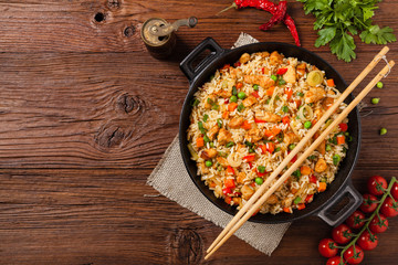 Fried rice with chicken. Prepared and served in a wok.